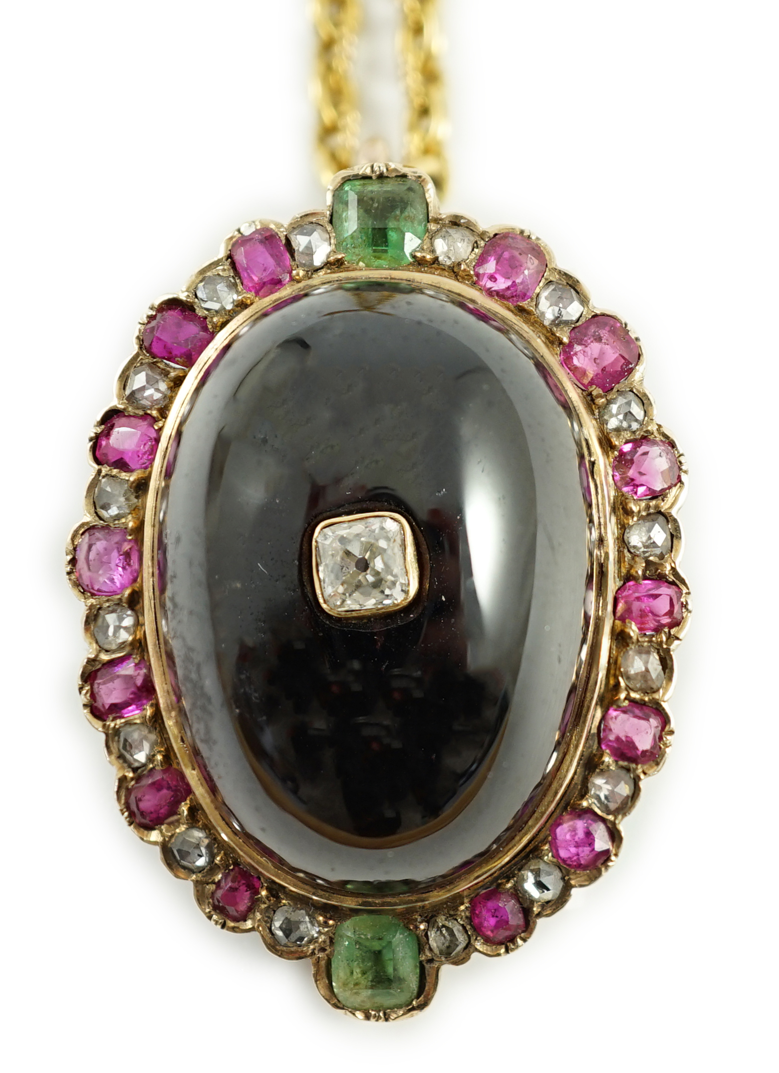 A gold, cabochon garnet, emerald, ruby and diamond cluster set oval pendant